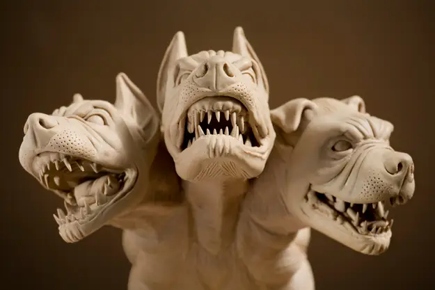 In Greek mythology, what was the name of the three-headed dog that guarded the gate to the underworld?